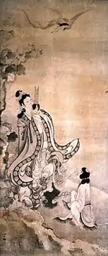 一位仙人望着空中的仙鶴,手持“弄玉”吹奏,童子坐在地上觀看