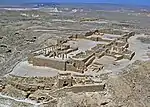 Ruins of buildings in a desert.