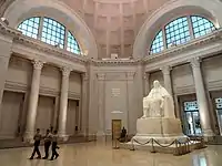 Seated statue of Benjamin Franklin in white marble