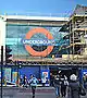 A building with scaffolding around it and a large window with a sign reading "UNDERGROUND" in white letters on a blue rectangle