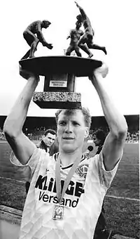 Sammer holds the East German Cup aloft in 1990.