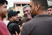 A man with graying hair is crying and visibly distressed.