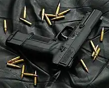 Photo of an all-black Five-seven USG with an extended 30-round magazine