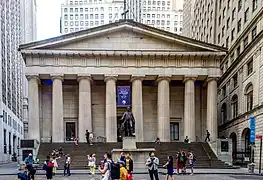 Neoclassical building with doric columns and a statue of George Washington