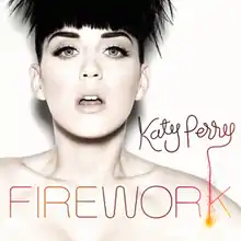 A woman with a firework hair like a boy and a white background and the brown letter is 'Katy Perry' and the orange letter is 'FIREWORK'