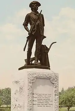 Crop of a color 20th-century postcard showing a bronze statue of a young man in colonial garb on a white pedestal.