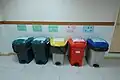 assorted colorful trash cans for medical wastes