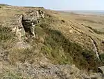 A line of rocks overlooking a plain.