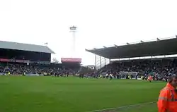 A corner of a football stadium on a cloudy day.