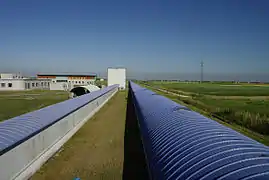 View of the 3 km-long Virgo west arm (right pipe). The tube on the left, which is 150 m-long, hosts the mode-cleaner cavity which is used to filter spatially the laser beam.