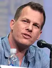 Jonathan Nolan is looking to his left