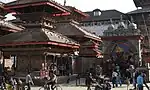 Streetscene with various characteristically shaped temple buildings.