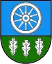 A coat of arms depicting a white wheel on a light blue background at the top and three white leaves on a green background at the bottom