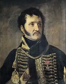 Painting shows a black-haired man with long sideburns and a moustache. He wears a dark hussar uniform