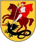 A coat of arms depicting a man in full body armour riding a brown horse that is trampling a black dragon all on a yellow background