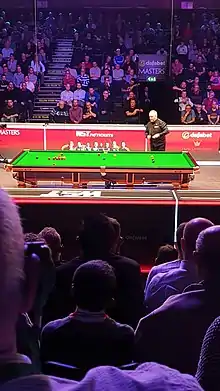 John Higgins preparing to take a shot