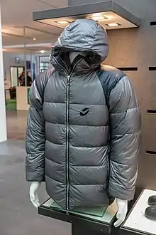 A thick, padded grey jacket with a zipper and hood