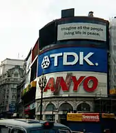 A colour photograph of a corner building on a busy corner in London.