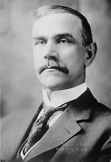 Upper-body portrait of a early-twentieth-century man in a suit.