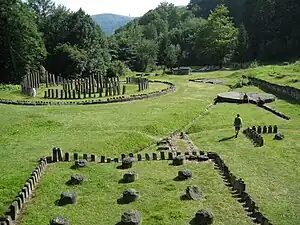 Ruins of different buildings in a grassy setting