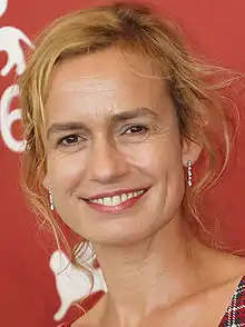 Sandrine Bonnaire at the 2009 Venice Film Festival, looking to the front and smiling