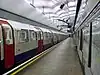 The interior of a building with a rounded ceiling and a white sign on the right wall reading "SEVEN SISTERS" in dark blue letters under a line