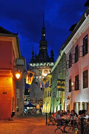 Town street in the evening. Old houses and a tower with a spire