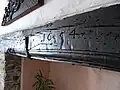 Simonsbath House, Simonsbath, Exmoor Parish, Devon. Wooden lintel over kitchen fireplace with carved date of 1654.