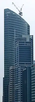 The topping out of the new Ocean Financial Centre in Singapore. In the foreground is Hitachi Tower.