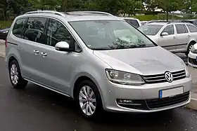 Front three-quarter view of a five-door road car with sliding rear-passenger doors.