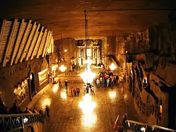 Underground hall from above, chandeliers and tourists