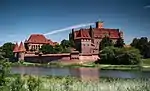 Front view of a castle tower in red brick